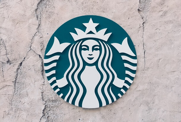 Green Starbucks logo attached to a white wall